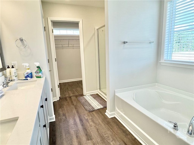 135 Melody Dr, Pooler, GA 31322 - full bathroom with a spacious closet, a bath, a stall shower, double vanity, and wood finished floors