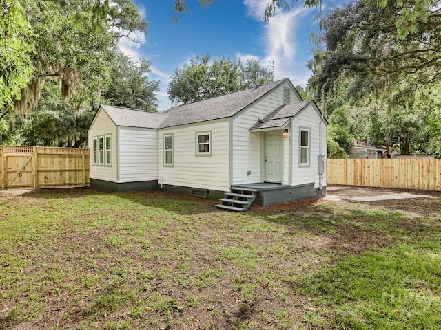 2409 E 37th St, Savannah, GA 31404 - back of house with crawl space, a fenced backyard, roof with shingles, and a gate