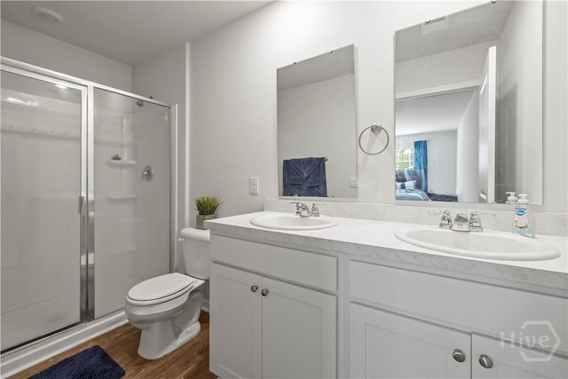 206 Coneflower Rd, Bloomingdale, GA 31302 - ensuite bathroom with double vanity, a stall shower, and wood finished floors
