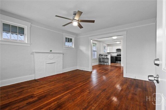 1122 SE 36th St, Savannah, GA 31404 - unfurnished living room with a ceiling fan, a brick fireplace, and dark wood finished floors