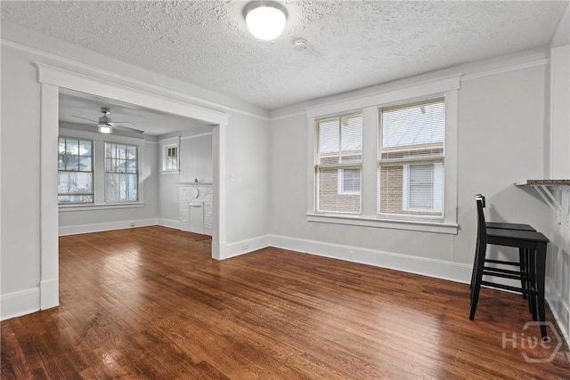 1122 SE 36th St, Savannah, GA 31404 - unfurnished living room with wood finished floors, a textured ceiling, and a ceiling fan