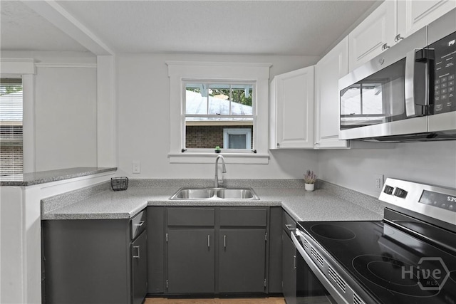 1122 SE 36th St, Savannah, GA 31404 - kitchen featuring stainless steel appliances, white cabinets, light countertops, a peninsula, and gray cabinetry