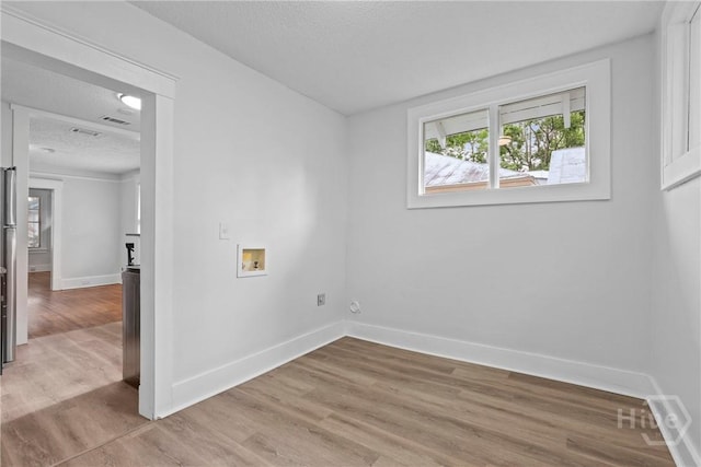 1122 SE 36th St, Savannah, GA 31404 - spare room featuring a textured ceiling and wood finished floors