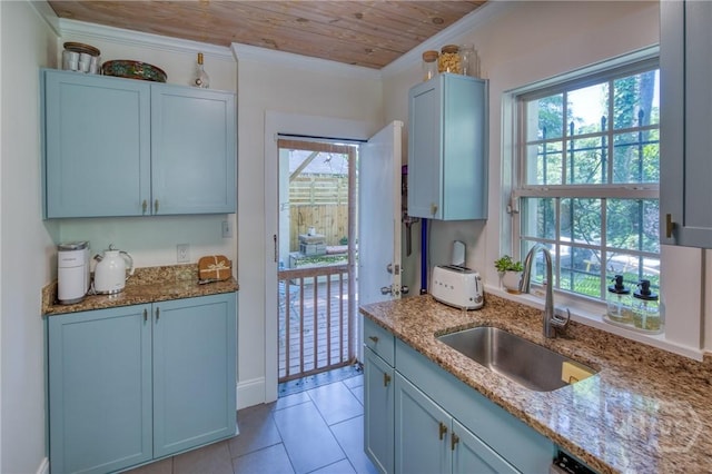 531 E 31st St, Savannah, GA 31401 - kitchen with light stone countertops, wood ceiling, plenty of natural light, crown molding, and light tile patterned flooring