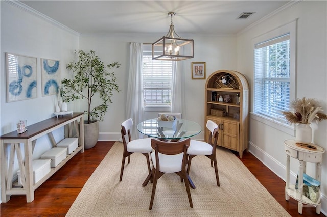 531 E 31st St, Savannah, GA 31401 - dining space with healthy amount of natural light, dark wood finished floors, a chandelier, and crown molding