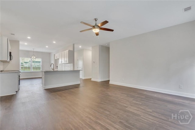 102 Simon Cir, Guyton, GA 31312 - unfurnished living room featuring a ceiling fan, dark wood-style flooring, and recessed lighting