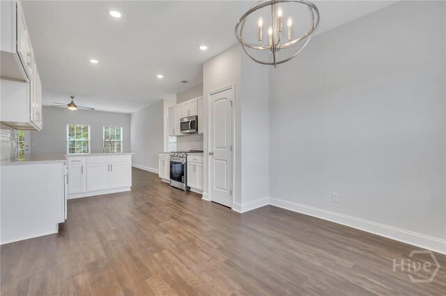 102 Simon Cir, Guyton, GA 31312 - unfurnished living room with a chandelier, a ceiling fan, dark wood-style flooring, and recessed lighting