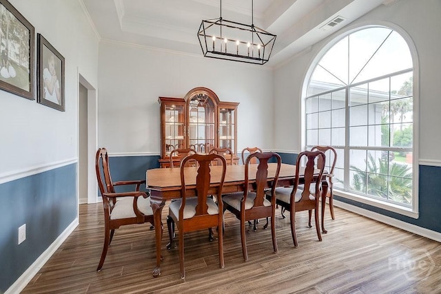 7 Settlers Pt, Savannah, GA 31406 - dining room featuring ornamental molding, wood finished floors, a raised ceiling, and a chandelier