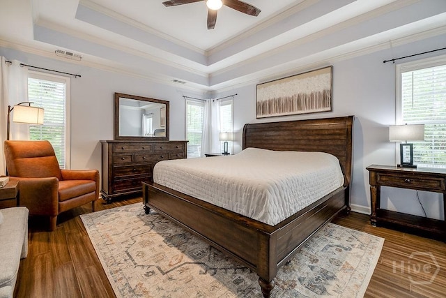 7 Settlers Pt, Savannah, GA 31406 - bedroom with ornamental molding, multiple windows, wood finished floors, a raised ceiling, and ceiling fan