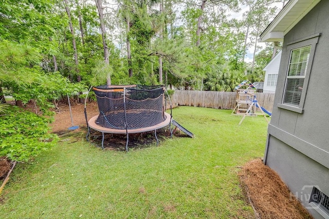 7 Settlers Pt, Savannah, GA 31406 - fenced backyard with a trampoline, a playground, and view of scattered trees