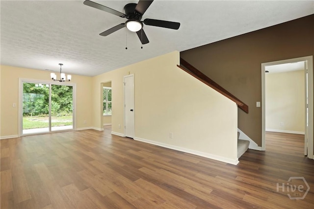 217 Bordeaux Ln, Savannah, GA 31419 - unfurnished living room featuring a chandelier, wood finished floors, stairs, and a ceiling fan