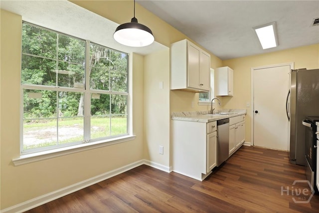 217 Bordeaux Ln, Savannah, GA 31419 - kitchen with appliances with stainless steel finishes, light countertops, healthy amount of natural light, and dark wood-type flooring