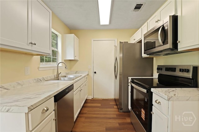 217 Bordeaux Ln, Savannah, GA 31419 - kitchen with appliances with stainless steel finishes, dark wood-style flooring, white cabinetry, and light countertops