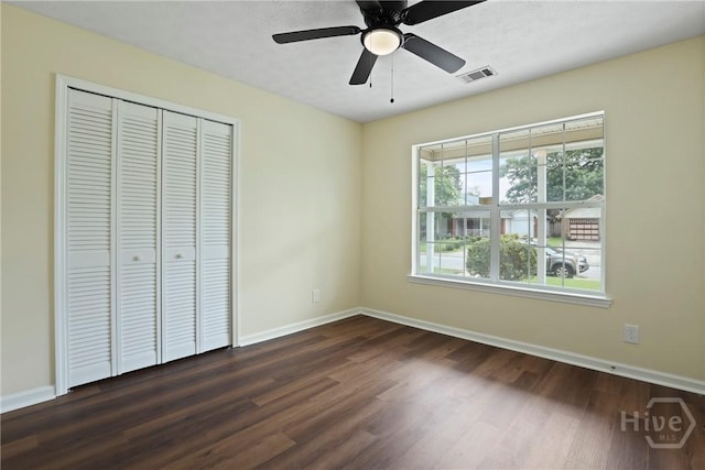 217 Bordeaux Ln, Savannah, GA 31419 - unfurnished bedroom with dark wood-style flooring, a closet, and a ceiling fan