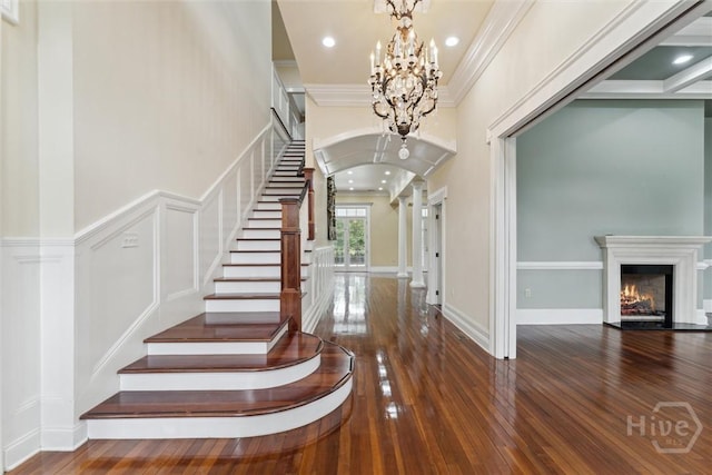 45 Shore Rd, Savannah, GA 31419 - entryway with a chandelier, hardwood / wood-style floors, stairway, arched walkways, and crown molding