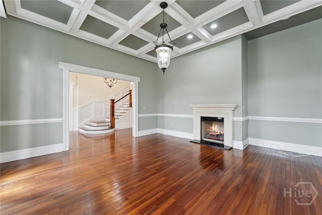 45 Shore Rd, Savannah, GA 31419 - unfurnished living room featuring stairway, coffered ceiling, wood-type flooring, a lit fireplace, and beamed ceiling