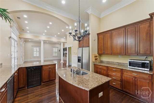 45 Shore Rd, Savannah, GA 31419 - kitchen with beverage cooler, appliances with stainless steel finishes, decorative columns, dark wood-style floors, and a center island with sink