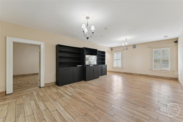 45 Shore Rd, Savannah, GA 31419 - unfurnished living room with a chandelier and light wood-type flooring