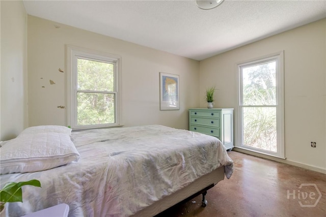 7012 Sandnettles Dr, Savannah, GA 31410 - bedroom featuring multiple windows and finished concrete floors