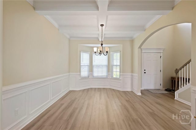1447 Arnold Dr SE, Allenhurst, GA 31301 - unfurnished dining area featuring coffered ceiling, beamed ceiling, light wood-style floors, arched walkways, and a chandelier