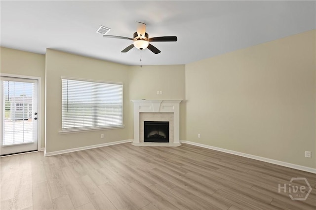 1447 Arnold Dr SE, Allenhurst, GA 31301 - unfurnished living room with ceiling fan, light wood-style floors, and plenty of natural light