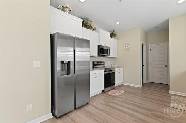 1447 Arnold Dr SE, Allenhurst, GA 31301 - kitchen featuring stainless steel appliances, white cabinets, light wood finished floors, backsplash, and recessed lighting