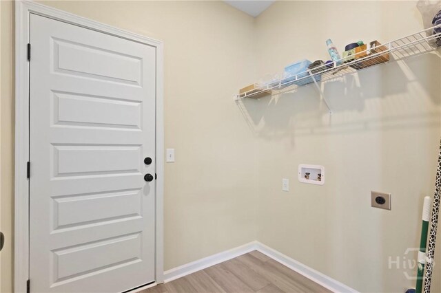 1447 Arnold Dr SE, Allenhurst, GA 31301 - washroom featuring electric dryer hookup, washer hookup, and light wood-type flooring