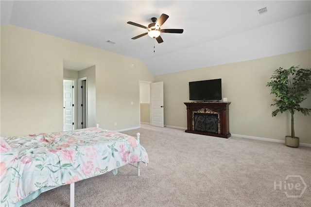 1447 Arnold Dr SE, Allenhurst, GA 31301 - carpeted bedroom with vaulted ceiling, ceiling fan, and a fireplace