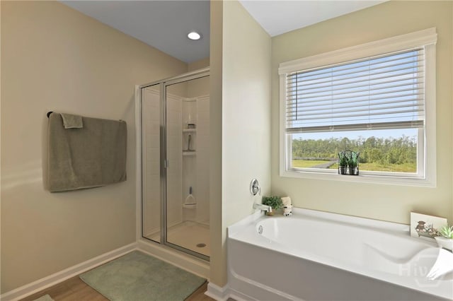 1447 Arnold Dr SE, Allenhurst, GA 31301 - full bath with a shower stall, a garden tub, and wood finished floors