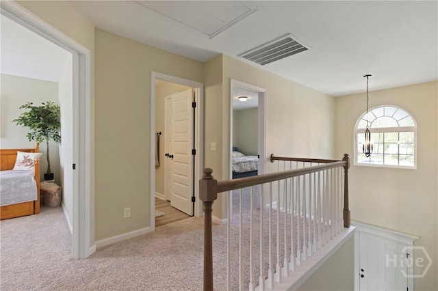1447 Arnold Dr SE, Allenhurst, GA 31301 - hall featuring an upstairs landing, carpet, and attic access