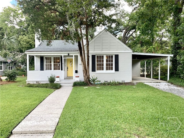 416 E 61st St, Savannah, GA 31405 - view of front of home featuring a front yard, gravel driveway, a carport, and covered porch