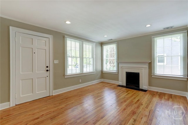 416 E 61st St, Savannah, GA 31405 - unfurnished living room with crown molding, light wood-type flooring, a brick fireplace, and recessed lighting