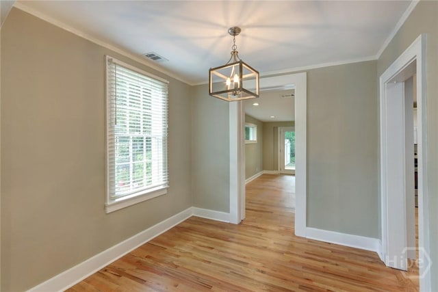 416 E 61st St, Savannah, GA 31405 - unfurnished dining area featuring a chandelier, crown molding, and light wood-style flooring