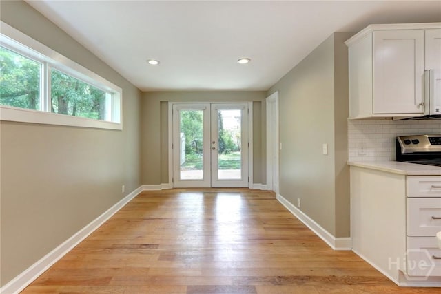 416 E 61st St, Savannah, GA 31405 - unfurnished dining area with light wood-style flooring, recessed lighting, and french doors