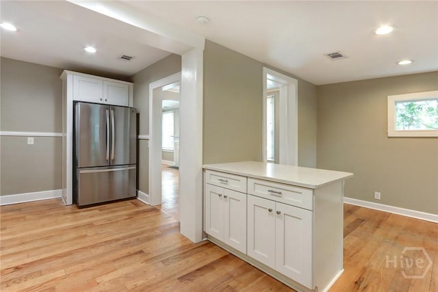 416 E 61st St, Savannah, GA 31405 - kitchen featuring freestanding refrigerator, light wood finished floors, white cabinets, light countertops, and recessed lighting