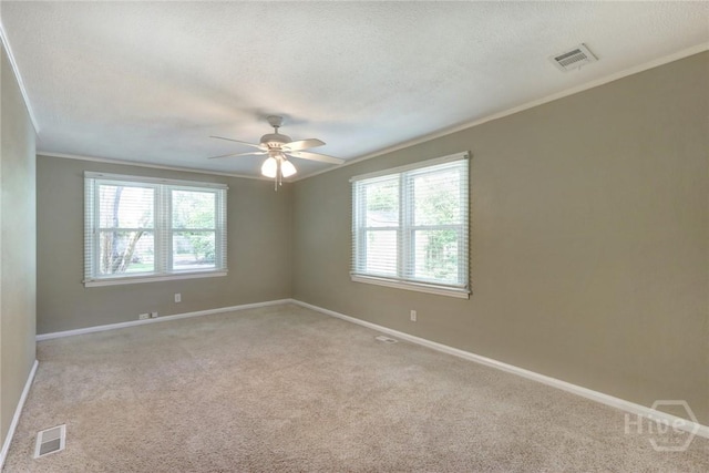 416 E 61st St, Savannah, GA 31405 - spare room featuring plenty of natural light, crown molding, light colored carpet, a ceiling fan, and a textured ceiling