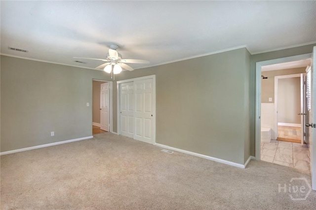 416 E 61st St, Savannah, GA 31405 - unfurnished bedroom with crown molding, carpet flooring, a closet, a ceiling fan, and ensuite bath