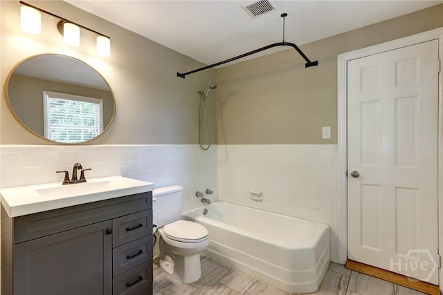 416 E 61st St, Savannah, GA 31405 - full bath with tile walls, vanity,  shower combination, and wainscoting