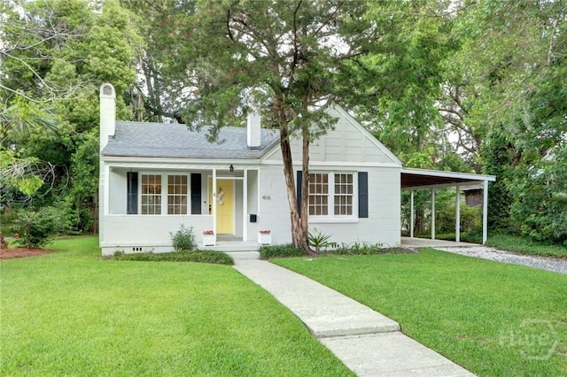 416 E 61st St, Savannah, GA 31405 - view of front facade featuring a chimney, a front lawn, an attached carport, and driveway