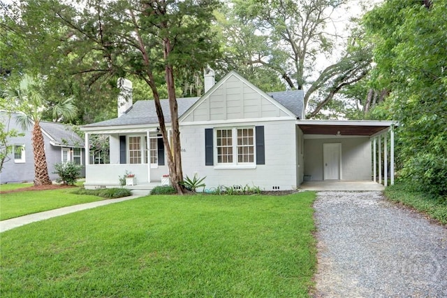 416 E 61st St, Savannah, GA 31405 - ranch-style home with driveway, a front yard, a chimney, roof with shingles, and a carport
