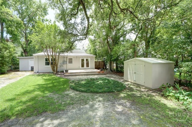 416 E 61st St, Savannah, GA 31405 - rear view of house with french doors, a storage shed, a yard, and view of scattered trees