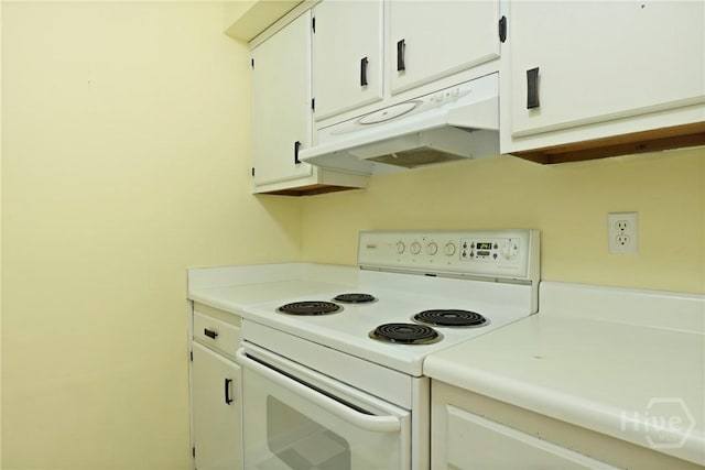 455 Mall Blvd Unit 39, Savannah, GA 31406 - kitchen featuring electric range, under cabinet range hood, light countertops, and white cabinetry