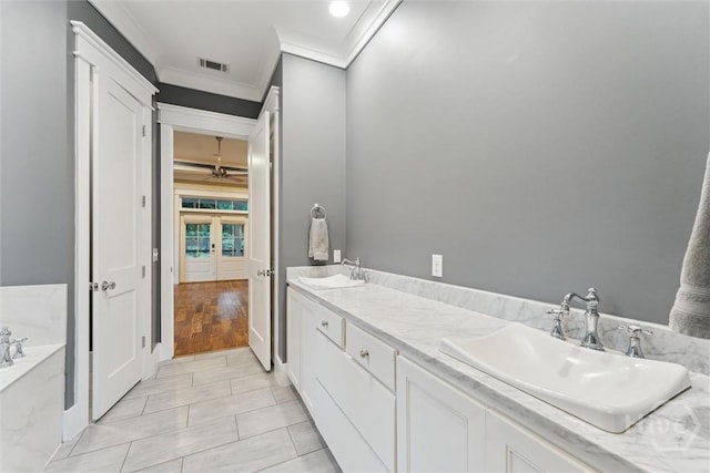 15 Sabal Dr, Richmond Hill, GA 31324 - bathroom featuring ornamental molding, a bath, french doors, double vanity, and ceiling fan