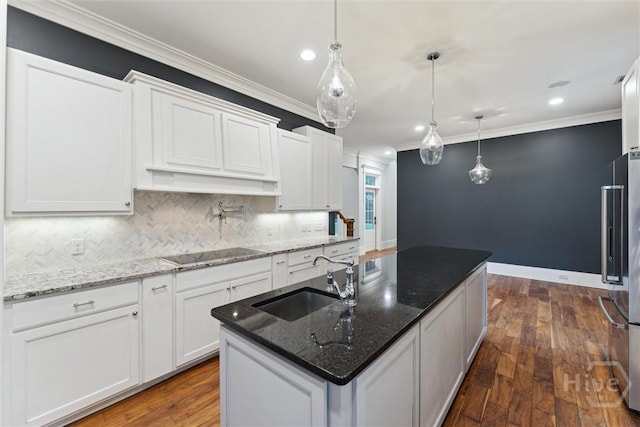 15 Sabal Dr, Richmond Hill, GA 31324 - kitchen featuring black electric cooktop, high end refrigerator, ornamental molding, backsplash, and white cabinets