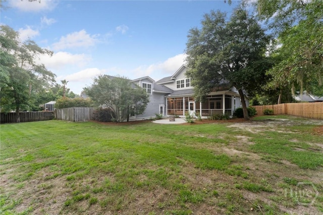 15 Sabal Dr, Richmond Hill, GA 31324 - rear view of house with a fenced backyard, a sunroom, and a patio