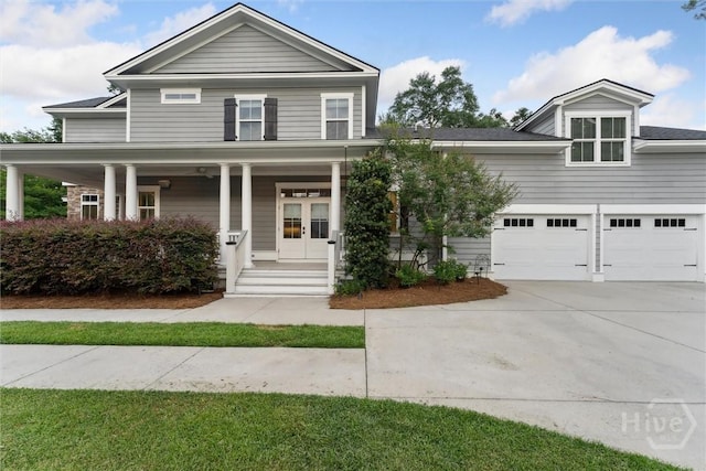 15 Sabal Dr, Richmond Hill, GA 31324 - view of front of home featuring driveway, french doors, covered porch, and a garage