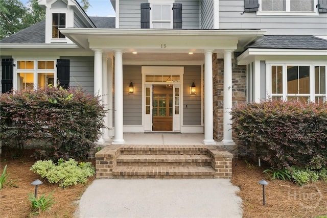 15 Sabal Dr, Richmond Hill, GA 31324 - entrance to property featuring covered porch, a shingled roof, and stone siding