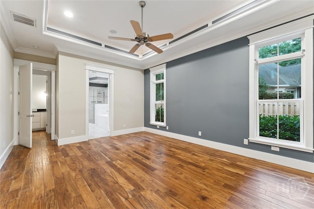 15 Sabal Dr, Richmond Hill, GA 31324 - unfurnished bedroom featuring crown molding, a tray ceiling, hardwood / wood-style floors, ensuite bathroom, and a ceiling fan