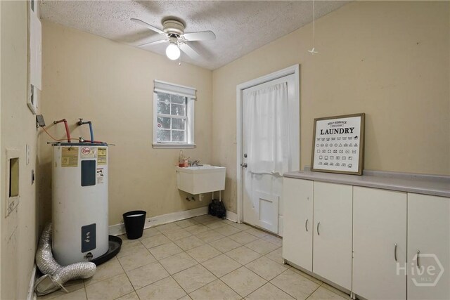 75 Brown Thrasher Ct, Richmond Hill, GA 31324 - washroom with electric water heater, a textured ceiling, ceiling fan, light tile patterned floors, and cabinet space