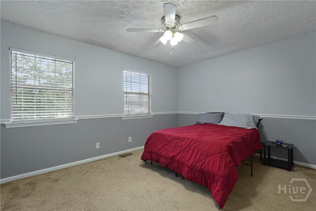 75 Brown Thrasher Ct, Richmond Hill, GA 31324 - carpeted bedroom with a textured ceiling and a ceiling fan
